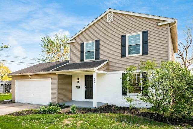 traditional home with concrete driveway and an attached garage
