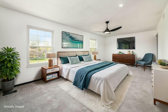 bedroom with visible vents, ceiling fan, carpet floors, and baseboards