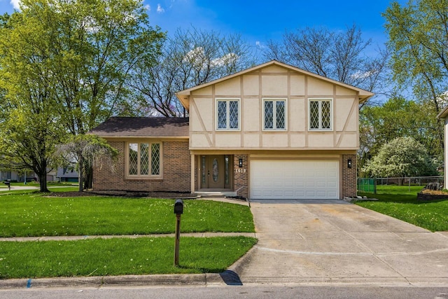 view of front of property featuring brick siding, fence, a garage, driveway, and a front yard