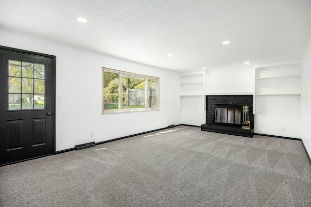 unfurnished living room with recessed lighting, a wealth of natural light, and carpet floors