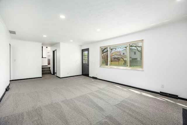 carpeted spare room featuring recessed lighting, stairs, visible vents, and baseboards