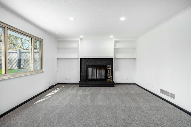 unfurnished living room with built in shelves, visible vents, carpet floors, and baseboards
