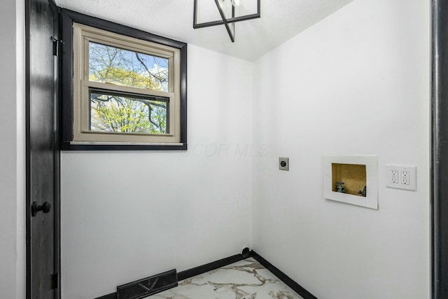 clothes washing area with electric dryer hookup, visible vents, marble finish floor, baseboards, and laundry area