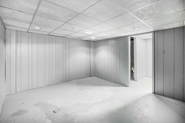 finished below grade area featuring a paneled ceiling and recessed lighting