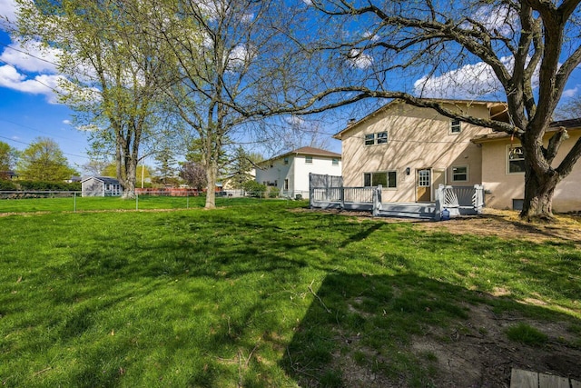 view of yard featuring fence and a deck