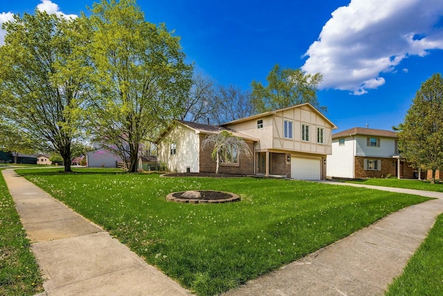 tri-level home featuring a front lawn, driveway, an attached garage, and brick siding