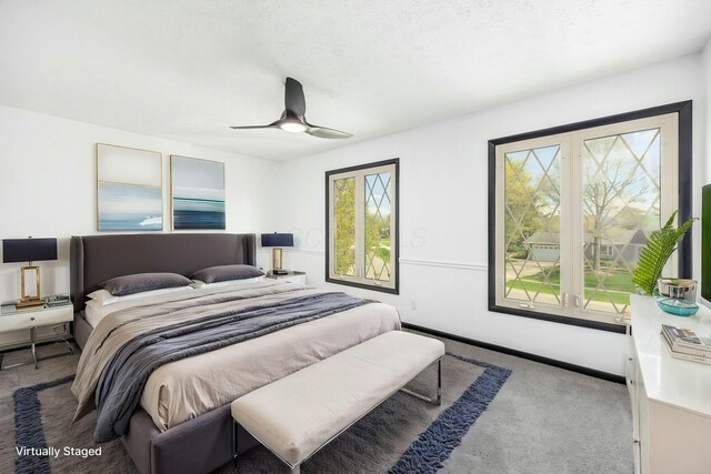 bedroom featuring baseboards, ceiling fan, and carpet flooring