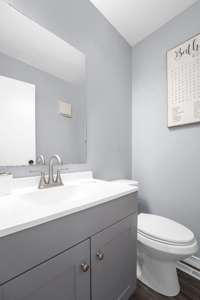 3236 Donalda Ct, Columbus, OH 43231 - bathroom with wood finished floors, vanity, and toilet