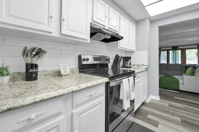 3236 Donalda Ct, Columbus, OH 43231 - kitchen featuring stainless steel range with electric cooktop, under cabinet range hood, white cabinets, tasteful backsplash, and light wood-style flooring