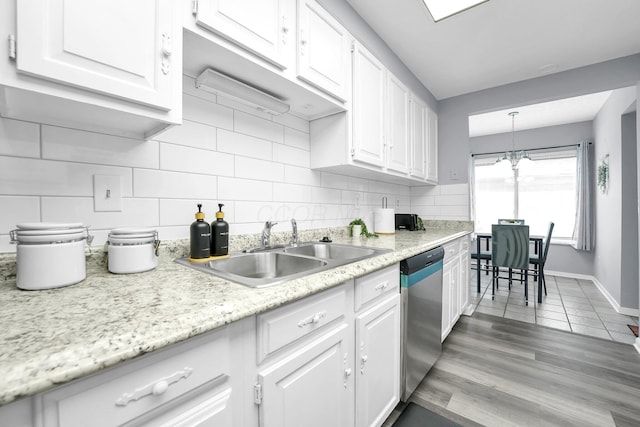 3236 Donalda Ct, Columbus, OH 43231 - kitchen featuring dishwasher, a sink, white cabinetry, decorative backsplash, and a chandelier
