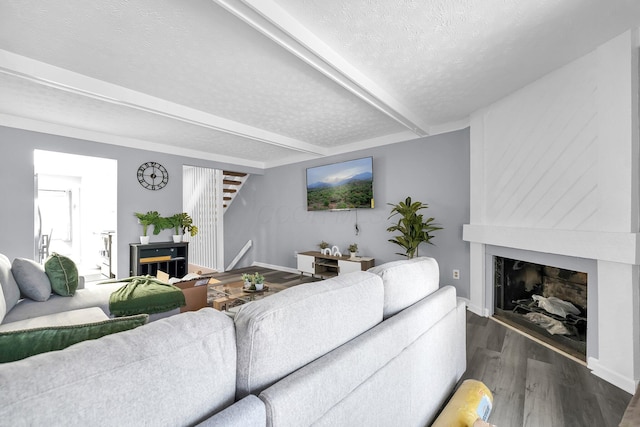 3236 Donalda Ct, Columbus, OH 43231 - living room featuring a large fireplace, a textured ceiling, baseboards, wood finished floors, and beam ceiling