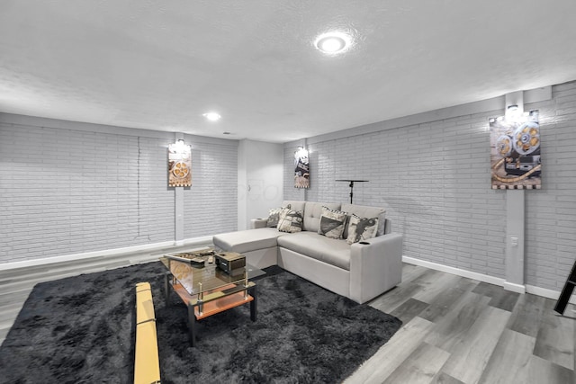 3236 Donalda Ct, Columbus, OH 43231 - living area with brick wall, wood finished floors, a textured ceiling, and baseboards