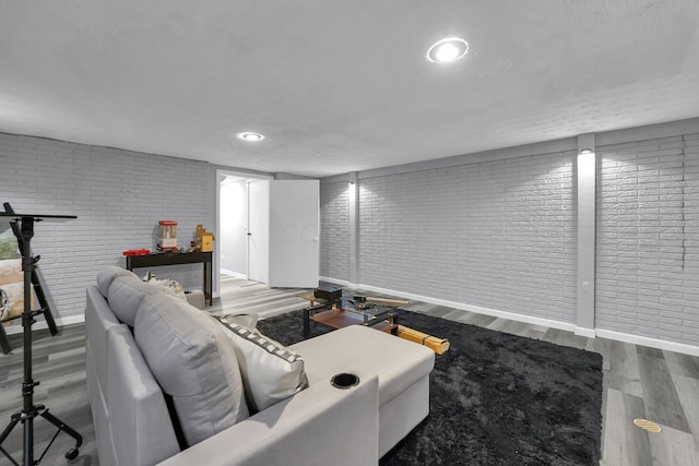 3236 Donalda Ct, Columbus, OH 43231 - living room featuring brick wall, wood finished floors, and baseboards