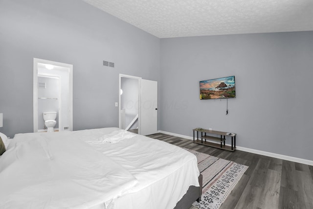 3236 Donalda Ct, Columbus, OH 43231 - bedroom with wood finished floors, a textured ceiling, a high ceiling, baseboards, and ensuite bath