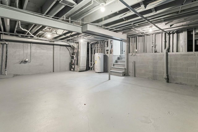 unfinished below grade area featuring heating unit, visible vents, and water heater
