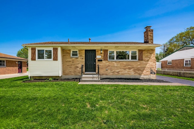 single story home featuring a front yard and brick siding