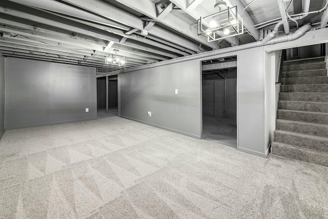 finished basement with stairs, carpet floors, and baseboards