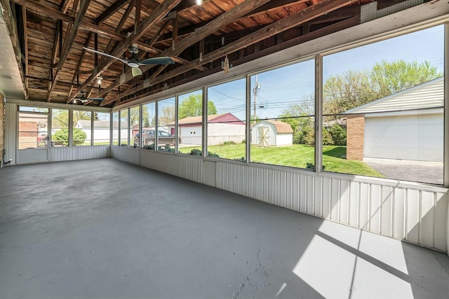 unfurnished sunroom featuring ceiling fan