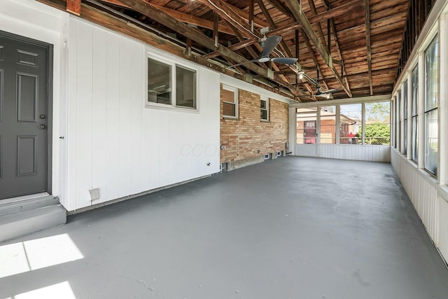 unfurnished sunroom with a ceiling fan