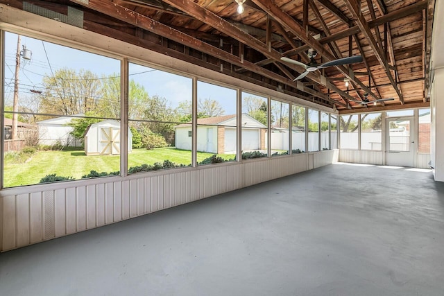 unfurnished sunroom featuring ceiling fan