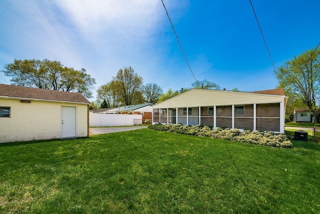 exterior space with a sunroom and fence