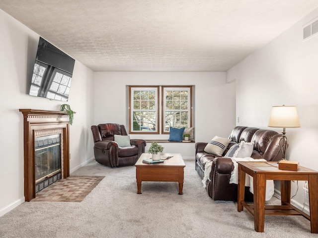 carpeted living room with a tile fireplace, a wealth of natural light, baseboards, and visible vents
