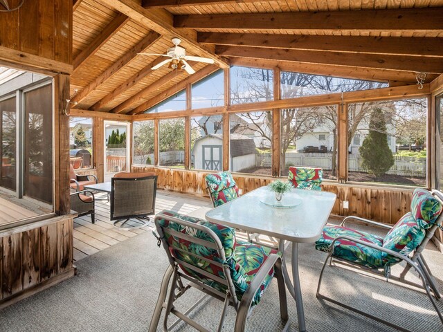 sunroom / solarium with outdoor dining space, beam ceiling, and ceiling fan
