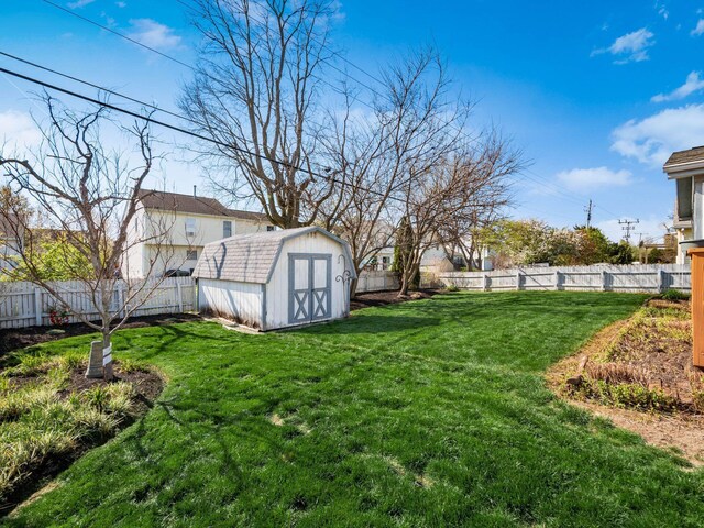 view of yard featuring an outdoor structure, a storage unit, and a fenced backyard