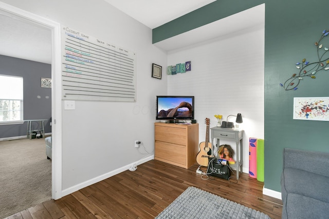 sitting room with baseboards and dark wood-style floors