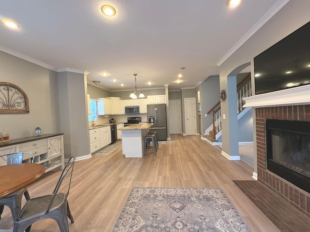 33 Hampden Dr, Granville, OH 43023 - living area with a fireplace, light wood finished floors, baseboards, recessed lighting, and crown molding