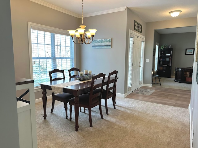 33 Hampden Dr, Granville, OH 43023 - dining space featuring light carpet, a chandelier, plenty of natural light, baseboards, and crown molding
