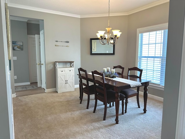 33 Hampden Dr, Granville, OH 43023 - dining room with light colored carpet, a chandelier, crown molding, and baseboards