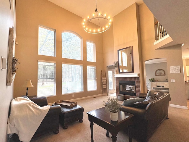 33 Hampden Dr, Granville, OH 43023 - living area featuring carpet, a high ceiling, a chandelier, a fireplace, and baseboards
