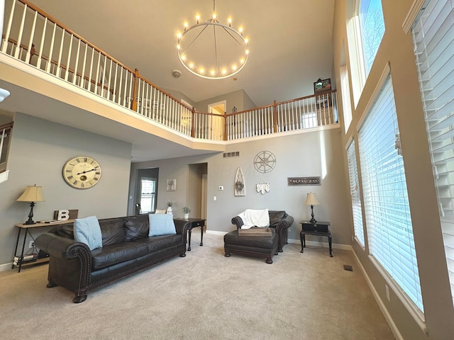 33 Hampden Dr, Granville, OH 43023 - carpeted living room with a chandelier, a high ceiling, and baseboards