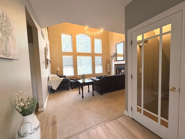 33 Hampden Dr, Granville, OH 43023 - interior space featuring a chandelier, a fireplace, baseboards, light carpet, and light wood-style floors
