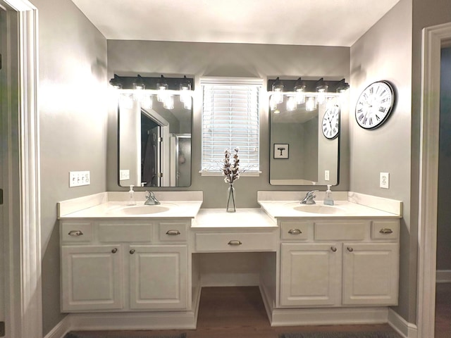 33 Hampden Dr, Granville, OH 43023 - bathroom with double vanity, wood finished floors, an enclosed shower, and baseboards