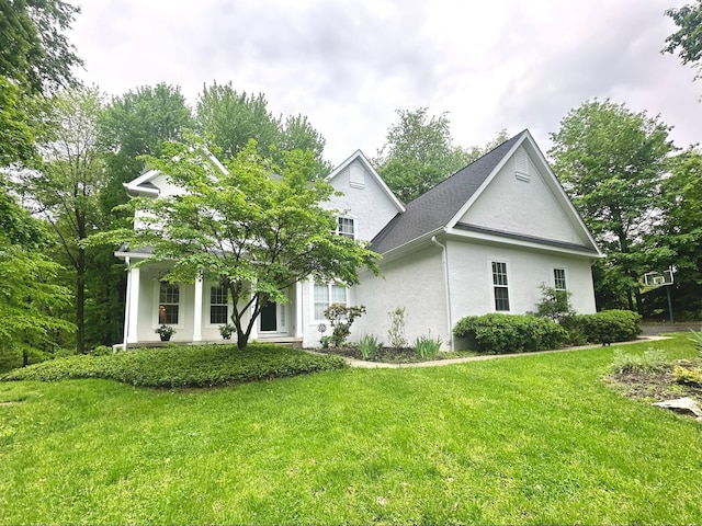 33 Hampden Dr, Granville, OH 43023 - view of side of home featuring stucco siding and a yard