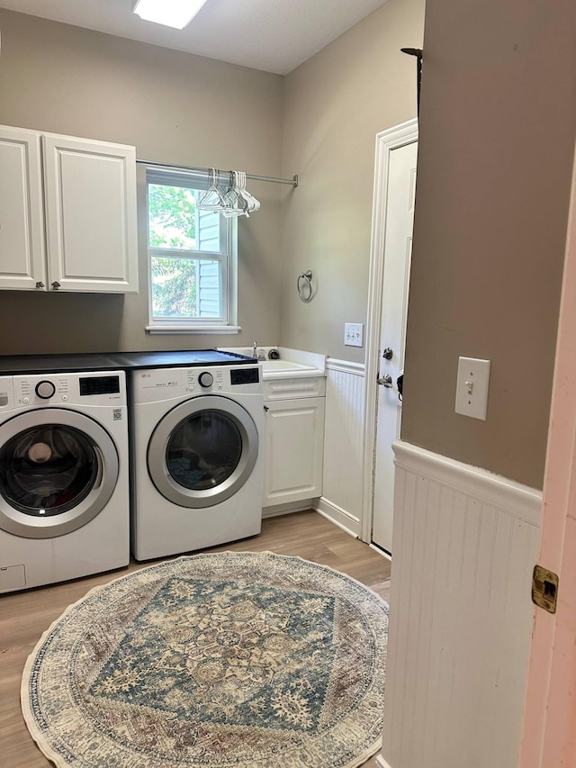 33 Hampden Dr, Granville, OH 43023 - laundry room with cabinet space, washing machine and clothes dryer, wainscoting, and light wood finished floors