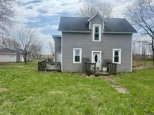 back of property with a yard and a deck