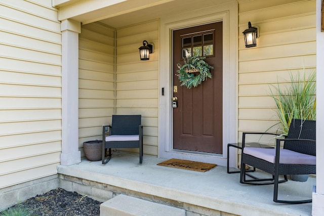 view of exterior entry featuring covered porch
