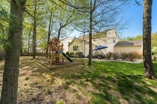 view of jungle gym with fence, a yard, and central air condition unit