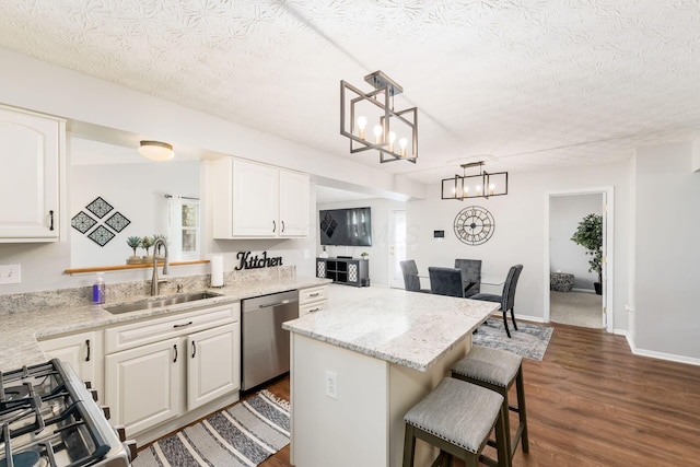 kitchen with a center island, a kitchen breakfast bar, a sink, stove, and dishwasher
