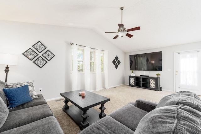 carpeted living area with lofted ceiling, baseboards, a ceiling fan, and visible vents