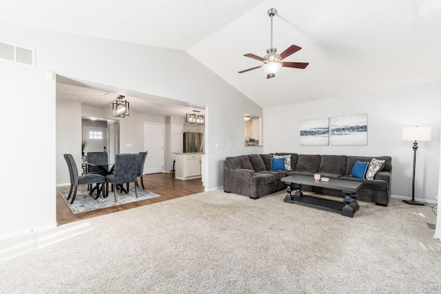 carpeted living area featuring vaulted ceiling, visible vents, a ceiling fan, and baseboards