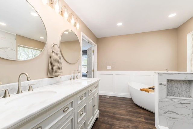 full bathroom with a wealth of natural light, a sink, and double vanity