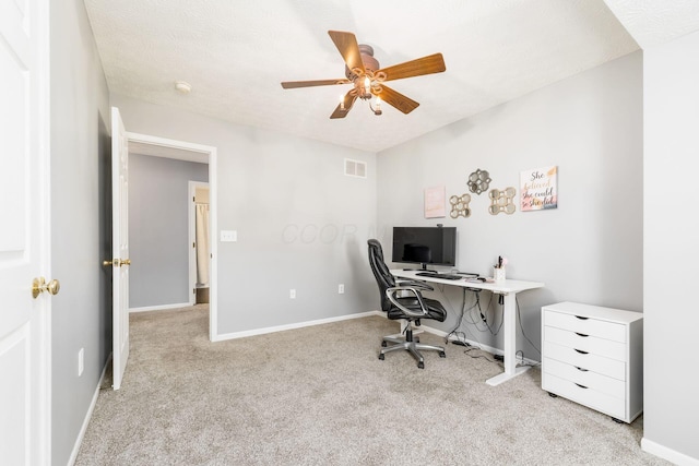 home office with baseboards, a ceiling fan, visible vents, and carpet floors
