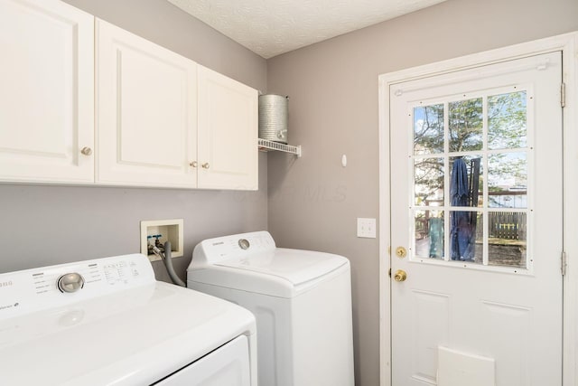 clothes washing area with cabinet space and separate washer and dryer