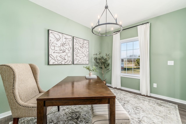 office featuring a notable chandelier, wood finished floors, and baseboards