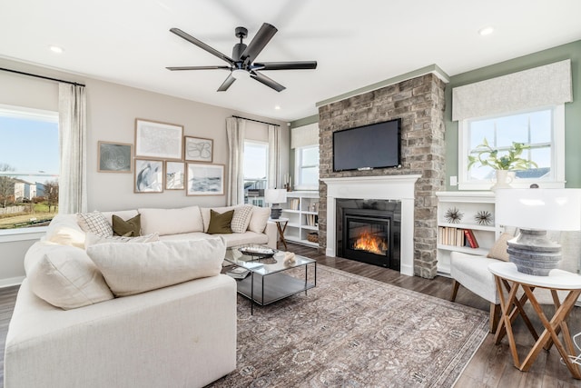 living room featuring a large fireplace, wood finished floors, ceiling fan, and recessed lighting