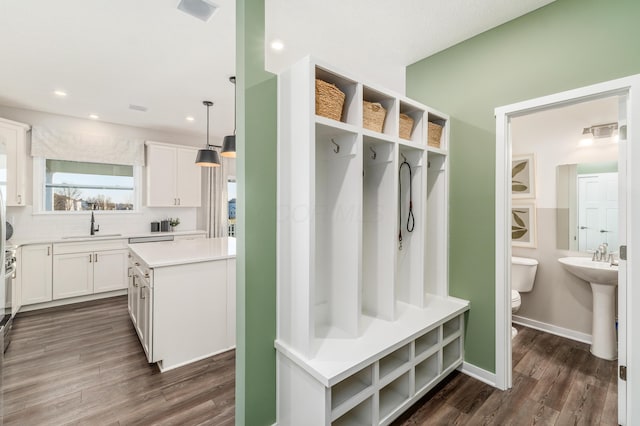 mudroom featuring recessed lighting, visible vents, a sink, and dark wood-type flooring